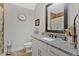 Bright bathroom featuring granite countertop, large mirror and white cabinets at 101 River Walk Pkwy, Euharlee, GA 30145