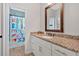 Bathroom featuring a white vanity with granite countertop and tiled shower with patterned curtain at 101 River Walk Pkwy, Euharlee, GA 30145
