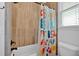 Bathroom featuring a tiled shower with a colorful shower curtain and window at 101 River Walk Pkwy, Euharlee, GA 30145