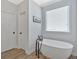 Relaxing bathroom with a freestanding tub and modern fixtures near a bright window at 101 River Walk Pkwy, Euharlee, GA 30145