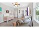Comfortable Bedroom with a crib, rocker, and bright window at 101 River Walk Pkwy, Euharlee, GA 30145