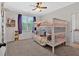 Bedroom showcasing a white bunk bed, plush carpet, and bright natural light at 101 River Walk Pkwy, Euharlee, GA 30145