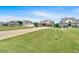 Wide shot of a picturesque neighborhood with beautiful homes sitting on green lawns under a blue sky at 101 River Walk Pkwy, Euharlee, GA 30145