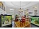 Traditional dining room with hardwood floors, chandelier, and large windows providing natural light at 101 River Walk Pkwy, Euharlee, GA 30145