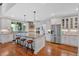 Open-concept kitchen with stainless steel appliances, island with seating, and modern lighting at 101 River Walk Pkwy, Euharlee, GA 30145