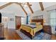 Vaulted ceiling main bedroom featuring exposed beams, hardwood floors and a sliding barn door at 101 River Walk Pkwy, Euharlee, GA 30145