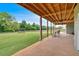 Wide, covered patio offers ample space for outdoor seating, views of the expansive, fenced yard at 101 River Walk Pkwy, Euharlee, GA 30145