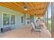 Spacious, covered patio features an outdoor fireplace, seating, and backyard views at 101 River Walk Pkwy, Euharlee, GA 30145