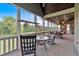 Relaxing screened porch featuring multiple seating areas, ceiling fans, and picturesque views of the surrounding landscape at 101 River Walk Pkwy, Euharlee, GA 30145