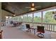 Inviting screened porch with multiple seating areas and ceiling fans, perfect for outdoor relaxation and entertaining at 101 River Walk Pkwy, Euharlee, GA 30145