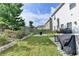 Landscaped backyard with patio table, grill, and fire pit at 1767 Weatherbrook Cir, Lawrenceville, GA 30043