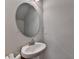 Bathroom featuring a pedestal sink, oval mirror, and neutral wall color at 1767 Weatherbrook Cir, Lawrenceville, GA 30043