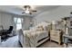 Bright bedroom with a white bed, soft carpet, and neutral decor at 1767 Weatherbrook Cir, Lawrenceville, GA 30043