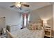 Comfortable bedroom with ceiling fan, soft carpet, and light-toned decor and furnishings at 1767 Weatherbrook Cir, Lawrenceville, GA 30043