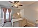 Cozy bedroom features a ceiling fan, plush carpet, and soft, inviting decor at 1767 Weatherbrook Cir, Lawrenceville, GA 30043