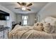 Bright bedroom with a white bed, soft carpet, and a wall-mounted television at 1767 Weatherbrook Cir, Lawrenceville, GA 30043