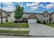 Charming two-story home with a well-manicured lawn and attached two car garage at 1767 Weatherbrook Cir, Lawrenceville, GA 30043
