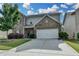 Charming two-story home with a well-manicured lawn and an attached two car garage at 1767 Weatherbrook Cir, Lawrenceville, GA 30043
