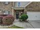 Inviting front porch with decorative bushes and a well manicured yard at 1767 Weatherbrook Cir, Lawrenceville, GA 30043