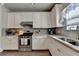 Bright kitchen featuring white cabinets, modern appliances, and stylish countertops at 1767 Weatherbrook Cir, Lawrenceville, GA 30043