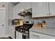 Cozy kitchen features stainless steel appliances, white cabinets, and granite countertops at 1767 Weatherbrook Cir, Lawrenceville, GA 30043