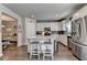 Open kitchen layout features an island, stainless steel appliances, and white cabinetry at 1767 Weatherbrook Cir, Lawrenceville, GA 30043
