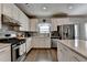 Bright kitchen featuring stainless steel appliances, tile backsplash and granite countertops at 1767 Weatherbrook Cir, Lawrenceville, GA 30043