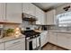 Beautiful kitchen features stainless steel appliances, white cabinets, and granite countertops at 1767 Weatherbrook Cir, Lawrenceville, GA 30043