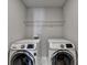Efficient laundry room with side-by-side Samsung washer and dryer at 1767 Weatherbrook Cir, Lawrenceville, GA 30043