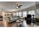 Open-concept living area includes a gray sectional sofa, hardwood floors, and natural light from the windows at 1767 Weatherbrook Cir, Lawrenceville, GA 30043
