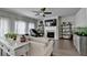 Bright open-concept living room featuring a fireplace, hardwood floors, and an abundance of natural light at 1767 Weatherbrook Cir, Lawrenceville, GA 30043