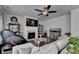 Bright living room featuring a fireplace, ceiling fan, dark hardwood floors, and modern decor at 1767 Weatherbrook Cir, Lawrenceville, GA 30043