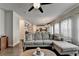 Open-concept living area features a comfortable gray sectional sofa with a view into the eat-in kitchen at 1767 Weatherbrook Cir, Lawrenceville, GA 30043