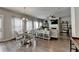 Open concept living and dining area with hardwood floors, natural light, and a fireplace at 1767 Weatherbrook Cir, Lawrenceville, GA 30043