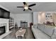 Modern living area features a gray sectional sofa, hardwood floors, aquarium, and fireplace at 1767 Weatherbrook Cir, Lawrenceville, GA 30043