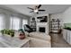 Bright open-concept living room featuring a fireplace, hardwood floors, and an abundance of natural light at 1767 Weatherbrook Cir, Lawrenceville, GA 30043