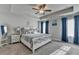 Bright main bedroom with tray ceilings, ceiling fan, and plush carpeting at 1767 Weatherbrook Cir, Lawrenceville, GA 30043
