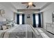 Inviting main bedroom with neutral tones and a decorative tray ceiling at 1767 Weatherbrook Cir, Lawrenceville, GA 30043