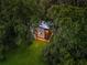Aerial view of a modern home surrounded by trees in a lush, green environment at 2105 Fairhaven Ne Cir, Atlanta, GA 30305