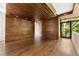 Spacious bedroom with wood paneling and ceiling, with access to a balcony and natural light at 2105 Fairhaven Ne Cir, Atlanta, GA 30305
