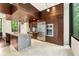 Kitchen with wood paneled ceiling, stainless steel appliances, stone island and large windows with natural light at 2105 Fairhaven Ne Cir, Atlanta, GA 30305