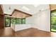 Bright living room featuring hardwood floors, wood accents, natural light, and balcony with great outdoor view at 2105 Fairhaven Ne Cir, Atlanta, GA 30305