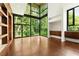 Bright, spacious living room with floor-to-ceiling windows overlooking wooded backyard at 2105 Fairhaven Ne Cir, Atlanta, GA 30305