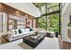 Bright living room featuring large windows, wood accents, comfortable seating, and stylish decor at 2105 Fairhaven Ne Cir, Atlanta, GA 30305