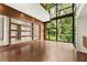 Expansive living room featuring hardwood floors and large windows with wooded views at 2105 Fairhaven Ne Cir, Atlanta, GA 30305
