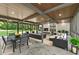 Inviting outdoor patio with fireplace, ample seating, and a view of the lush backyard at 2105 Fairhaven Ne Cir, Atlanta, GA 30305