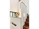 A unique light fixture hangs above the wooden staircase with white walls at 2105 Fairhaven Ne Cir, Atlanta, GA 30305