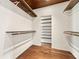 Walk-in closet featuring hardwood floors, hanging rods, and shelving to maximize organization space at 2105 Fairhaven Ne Cir, Atlanta, GA 30305