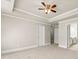 Spacious bedroom features tray ceiling, ceiling fan, neutral paint, and carpet flooring at 2345 Gallard St, Lawrenceville, GA 30043