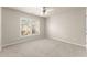 A carpeted bedroom with neutral walls, ceiling fan, and a window with a neighborhood view at 2345 Gallard St, Lawrenceville, GA 30043